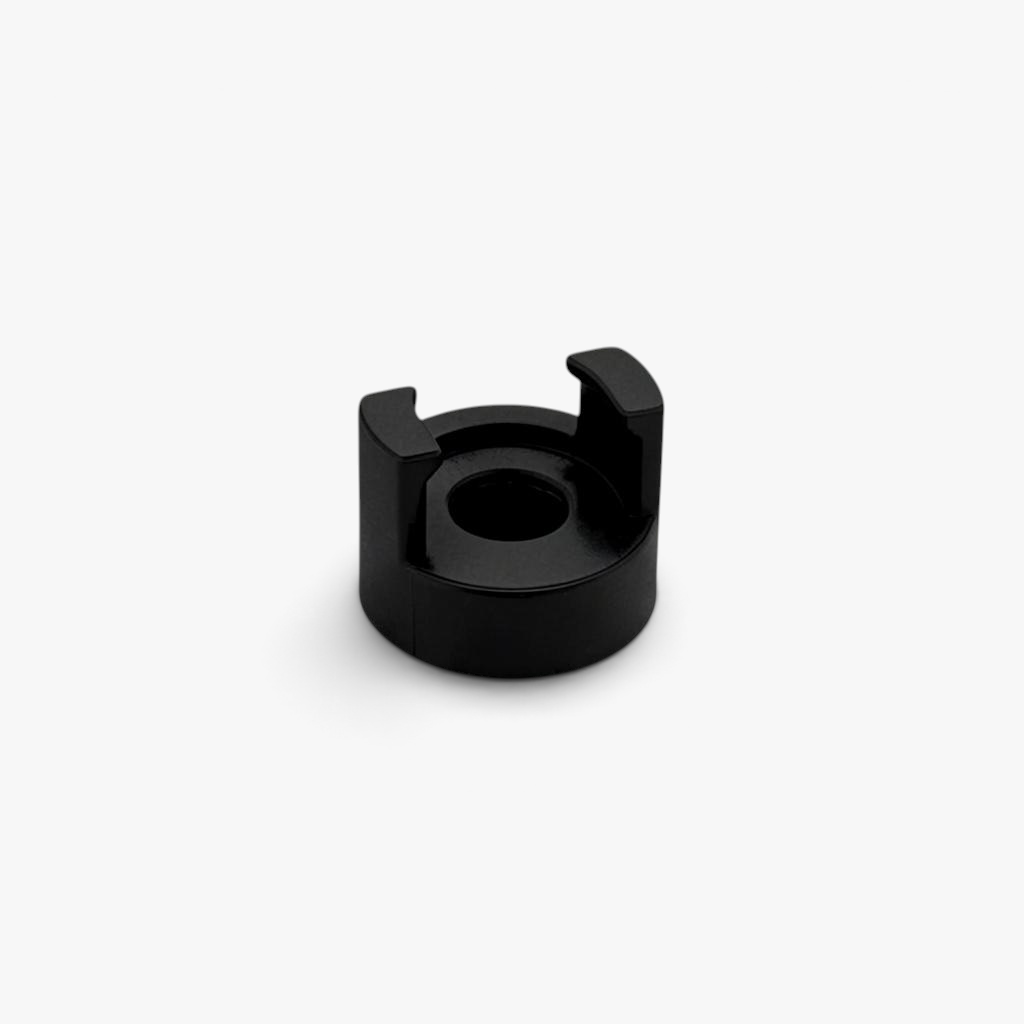 Black FŪTL Bobbin Top accessory designed to hold a bobbin on top of industrial sewing thread spool.